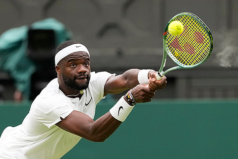Francis Tiafoe plays a backhand return to Carlos Alcaraz 